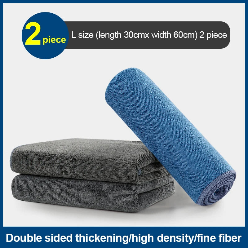 Two blue microfiber cleaning towels are shown next to a stack of gray ones.