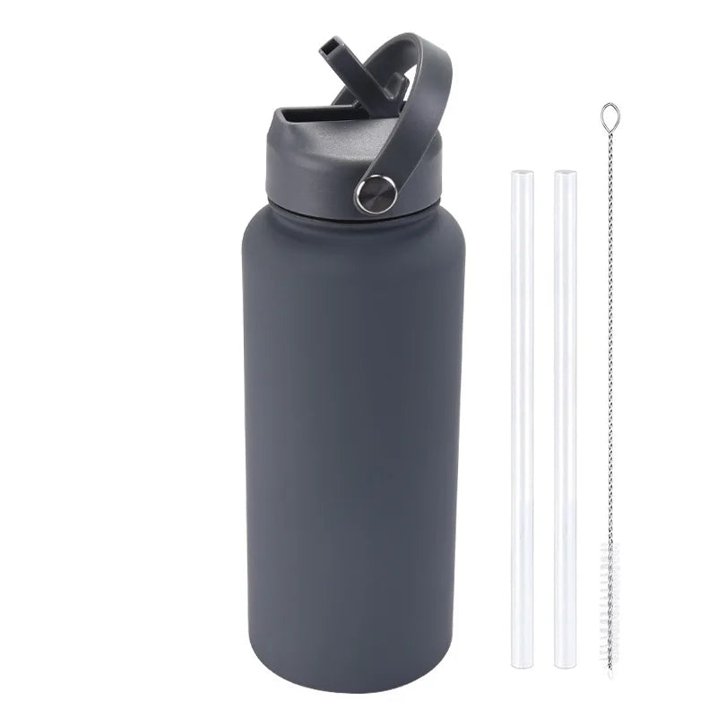 A dark gray stainless steel vacuum flask water bottle with a hinged straw lid and a separate metal straw.