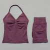 A mauve women's seamless fitness set consisting of a cropped top and matching capri-length bottoms.
