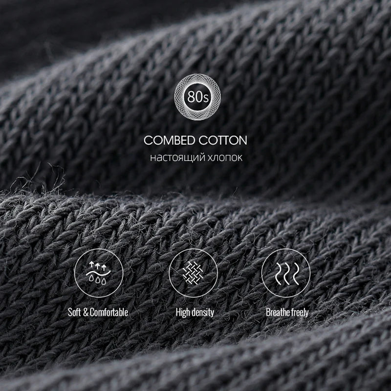 Close-up of dark gray combed cotton knitted fabric showing texture and quality details.
