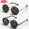 A pair of gold-framed polarized round sunglasses with black lenses shown against a white background.