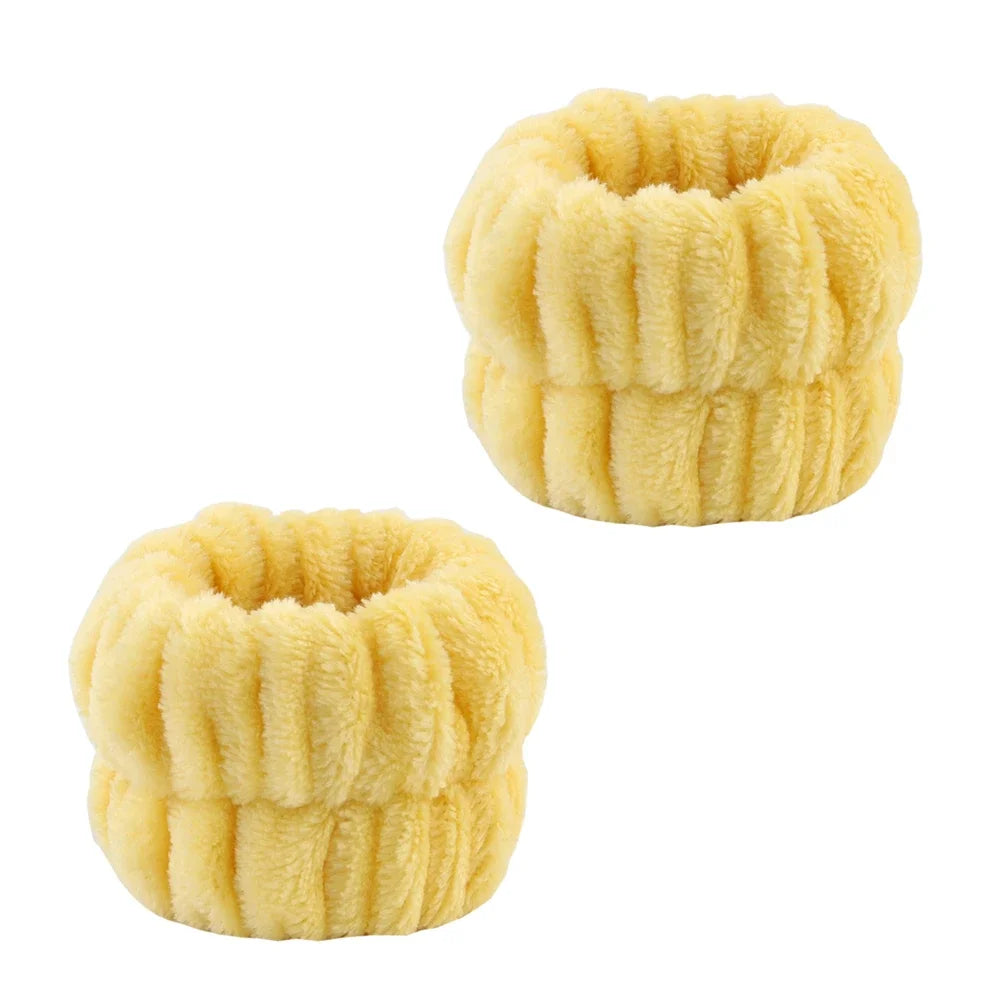 A set of yellow microfiber spa headband and wristband, both featuring a textured, ribbed design.