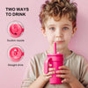 A young boy holds a pink stainless steel travel mug, demonstrating two ways to drink: suction nozzle and straight drink.