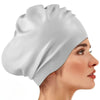 A white silicone swim cap is shown on a model's head, highlighting its smooth texture and fit.