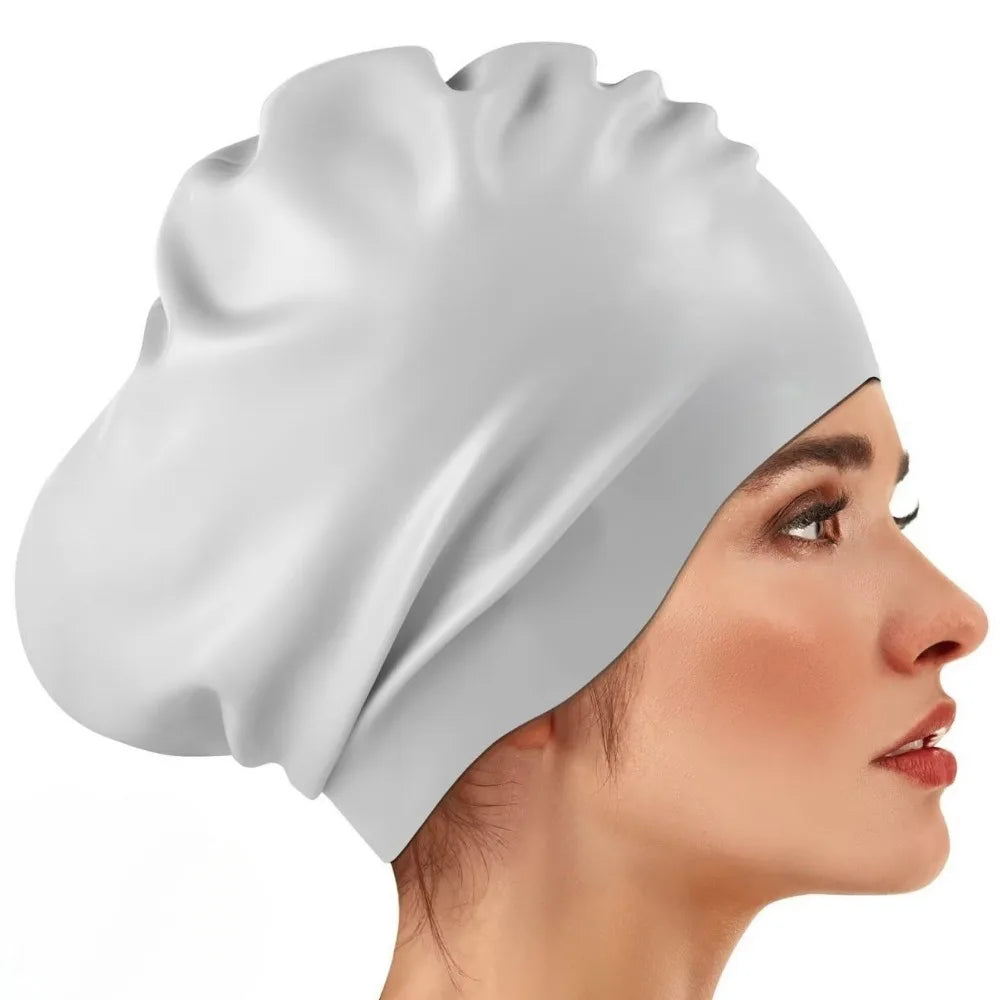 A white silicone swim cap is shown on a model's head, highlighting its smooth texture and fit.