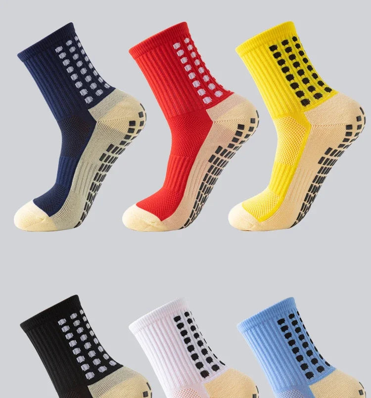 A collection of brightly colored performance sports grip socks displayed in various shades including navy, red, yellow, black