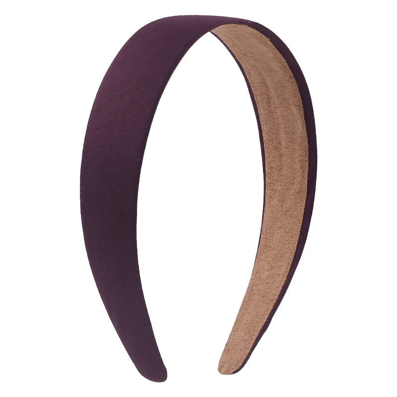 A pair of solid satin hair bands in purple and tan colors shown against a white background.
