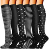 A pair of black compression socks with white stripes and polka dots shown from the ankle up.