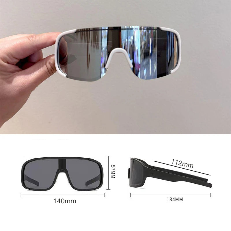 A pair of clear-lensed sports sunglasses with white frames shown being held by a hand, along with dimension diagrams.