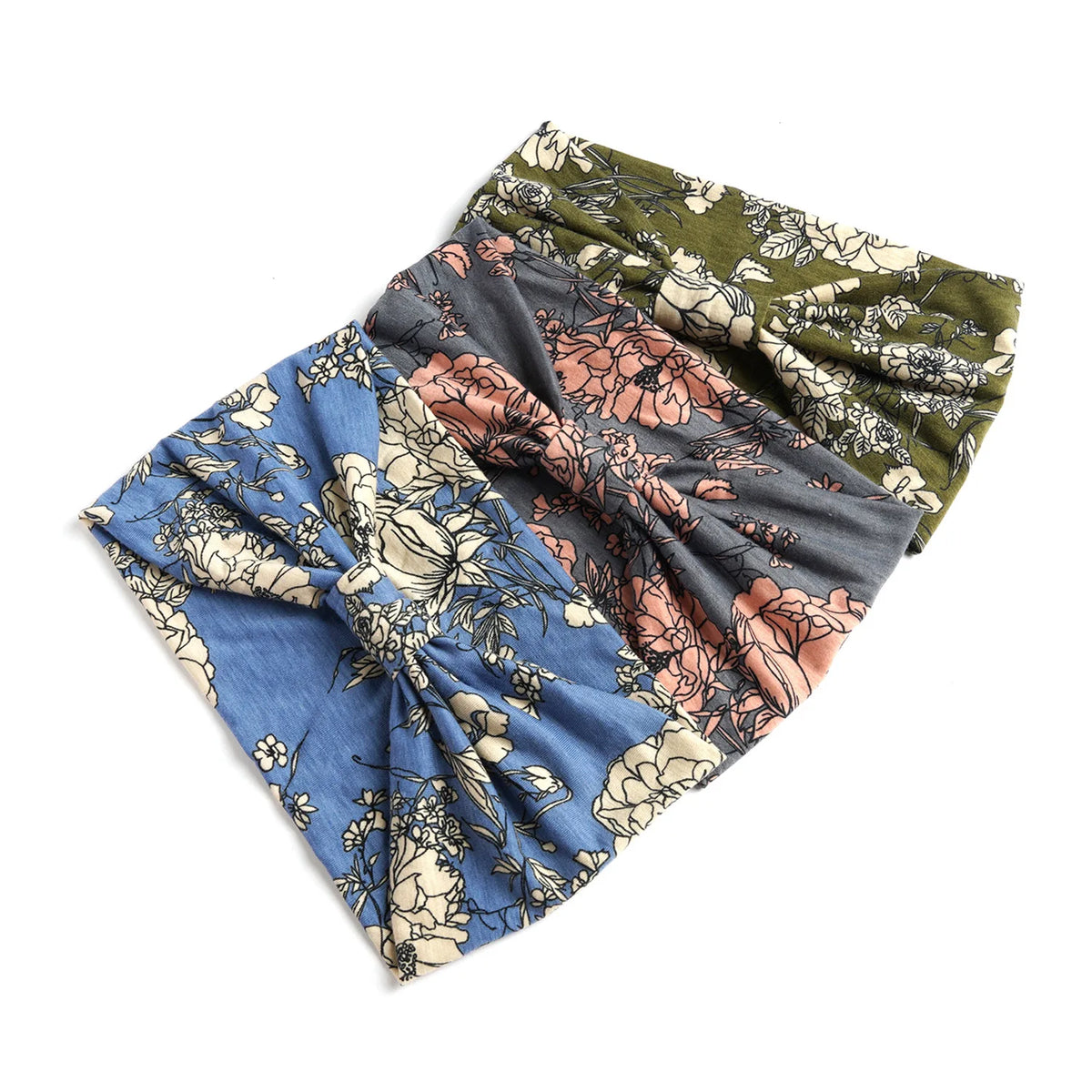 A stack of bohemian cotton stretch headbands in floral patterns featuring blue, pink, and olive green tones.