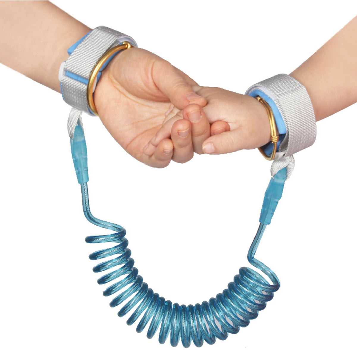 A hand is holding a blue, coiled safety harness and leash for a toddler.