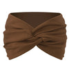 A brown twisted criss cross elastic headband is shown folded and tied