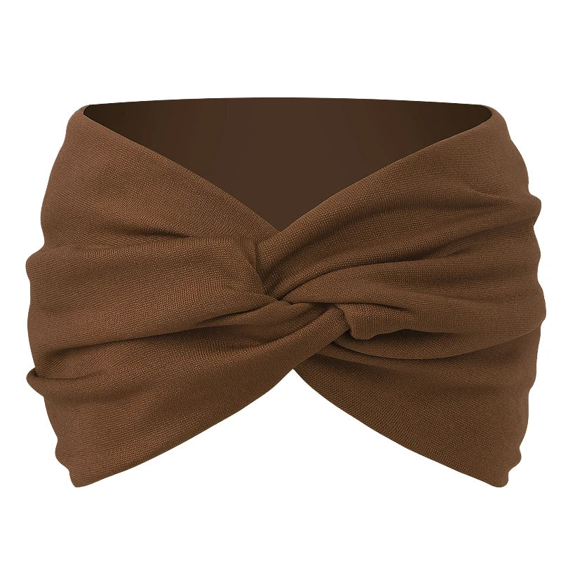 A brown twisted criss cross elastic headband is shown folded and tied