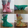 A set of funny animal crocodile knit socks in pink and green colors shown from different angles.