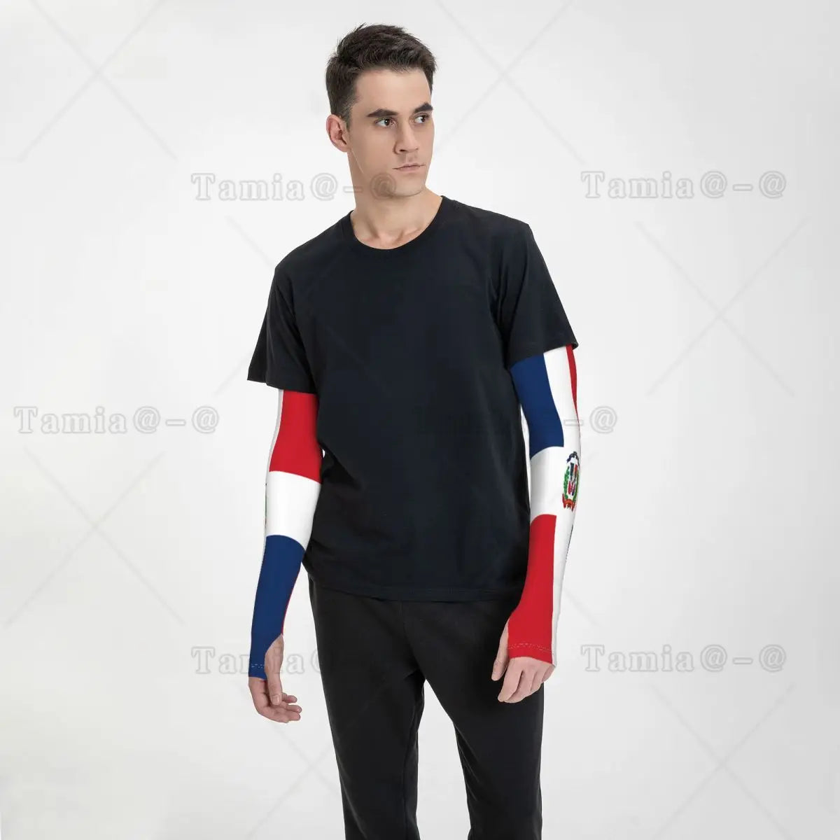 A man wearing a black t-shirt with red and blue UV protection arm sleeves on his left arm.