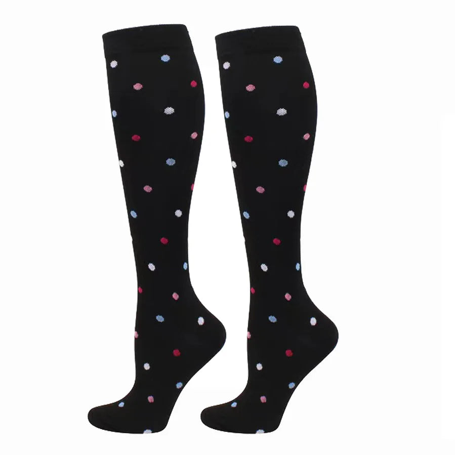 A pair of black compression elastic socks with scattered colorful dots.
