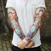 Close-up of a person wearing colorful, detailed dragon and warrior themed arm sleeves on a white t-shirt.