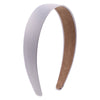 A white satin hair band with a brown suede accent shown from the side.
