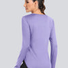 A woman wearing a purple loose fit sun protection t-shirt, shown from the back.
