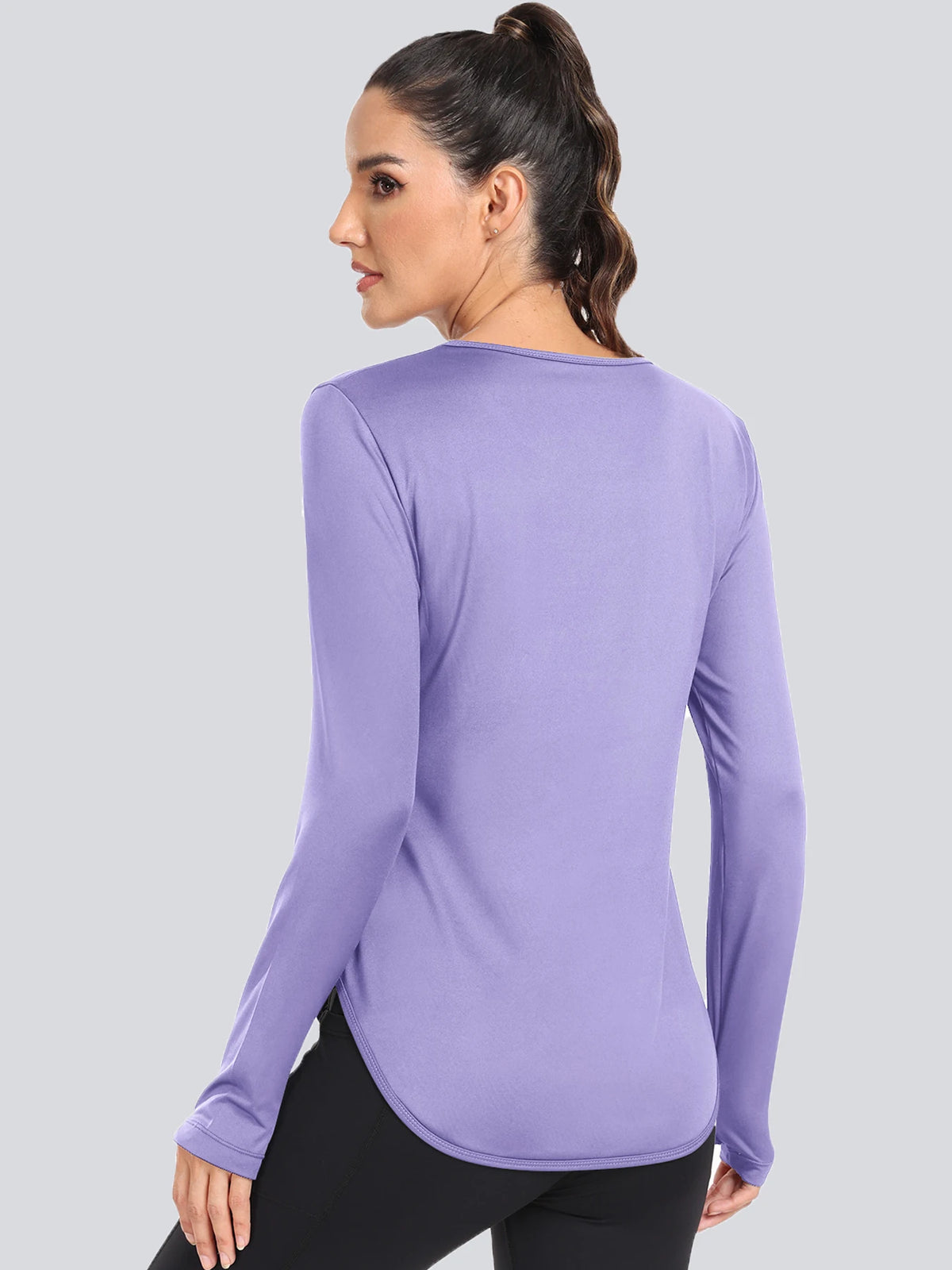 A woman wearing a purple loose fit sun protection t-shirt, shown from the back.