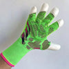 A hand wearing bright lime green goalkeeper gloves with black and pink accents.
