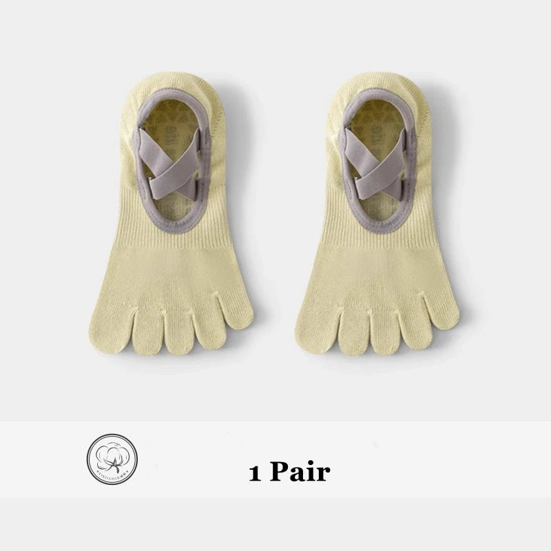 A pair of beige five-finger invisible yoga and fitness socks with a strap detail.