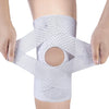 A person is holding a white adjustable knee brace with compression support, demonstrating its design.