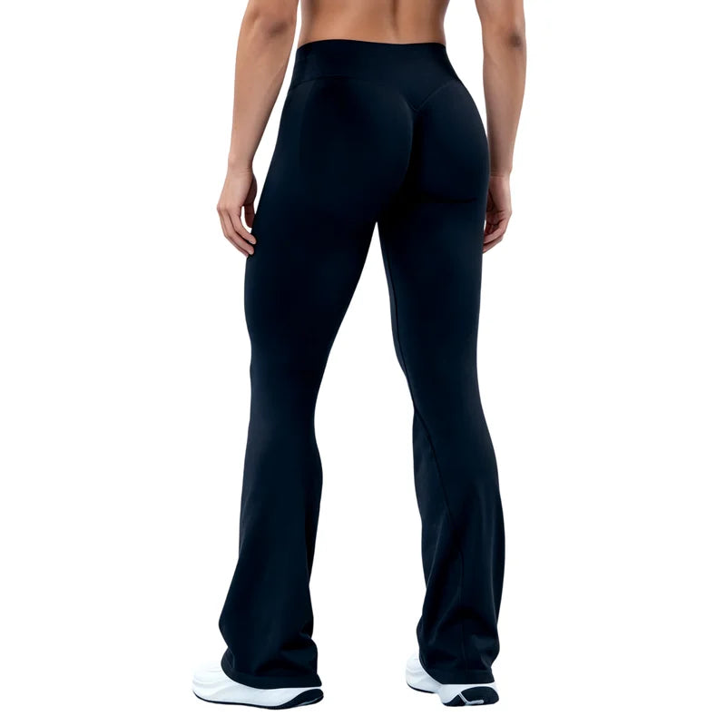A person wearing dark blue seamless flared yoga leggings standing, viewed from the front.
