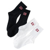 A pair of black and white men's classic crew socks with red numbers 23