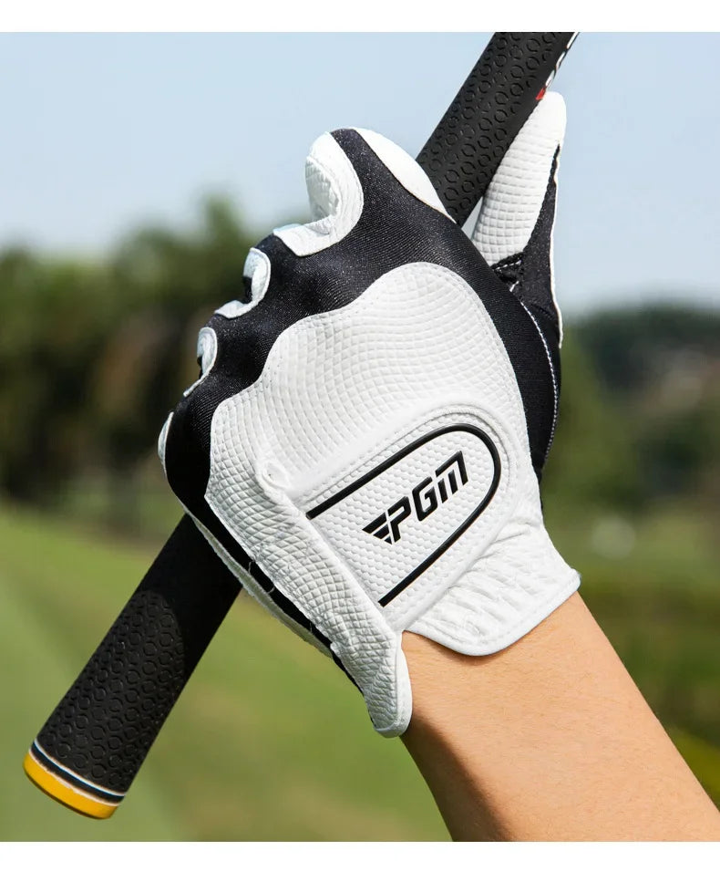 A close-up of a white and black men's golf glove being worn on a wrist.