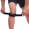 A person is applying an adjustable knee patellar tendon support strap to their leg.