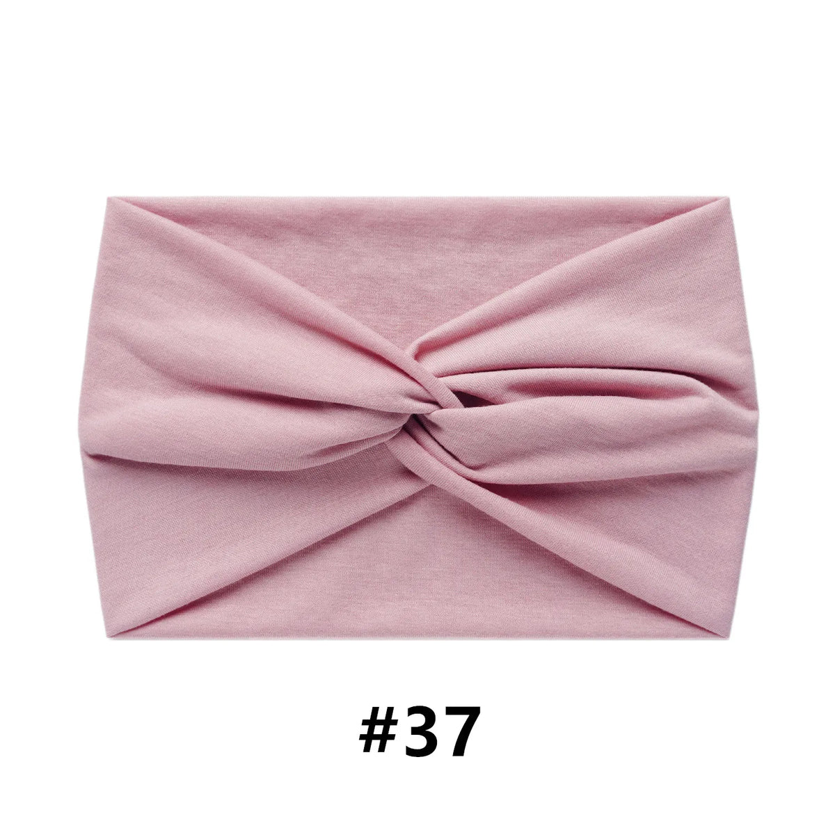 A folded dusty rose fabric headband or turban for women.