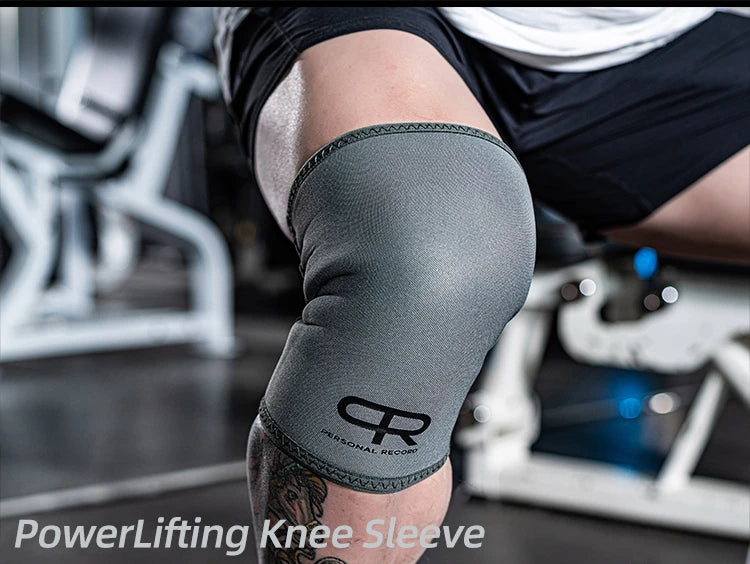 A close-up of a gray knee sleeve worn on an arm during a workout, featuring a personalized logo.