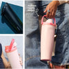 A pink insulated stainless steel travel mug being held by a hand, shown in various angles.