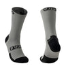 A pair of gray cycling socks with black accents and the GKRO logo visible on the calf.