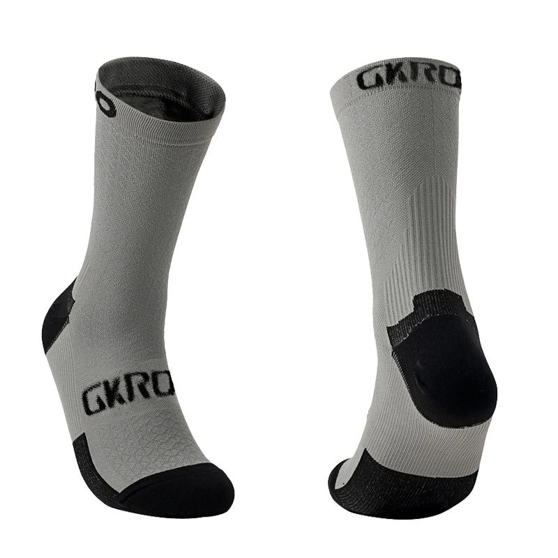 A pair of gray cycling socks with black accents and the GKRO logo visible on the calf.