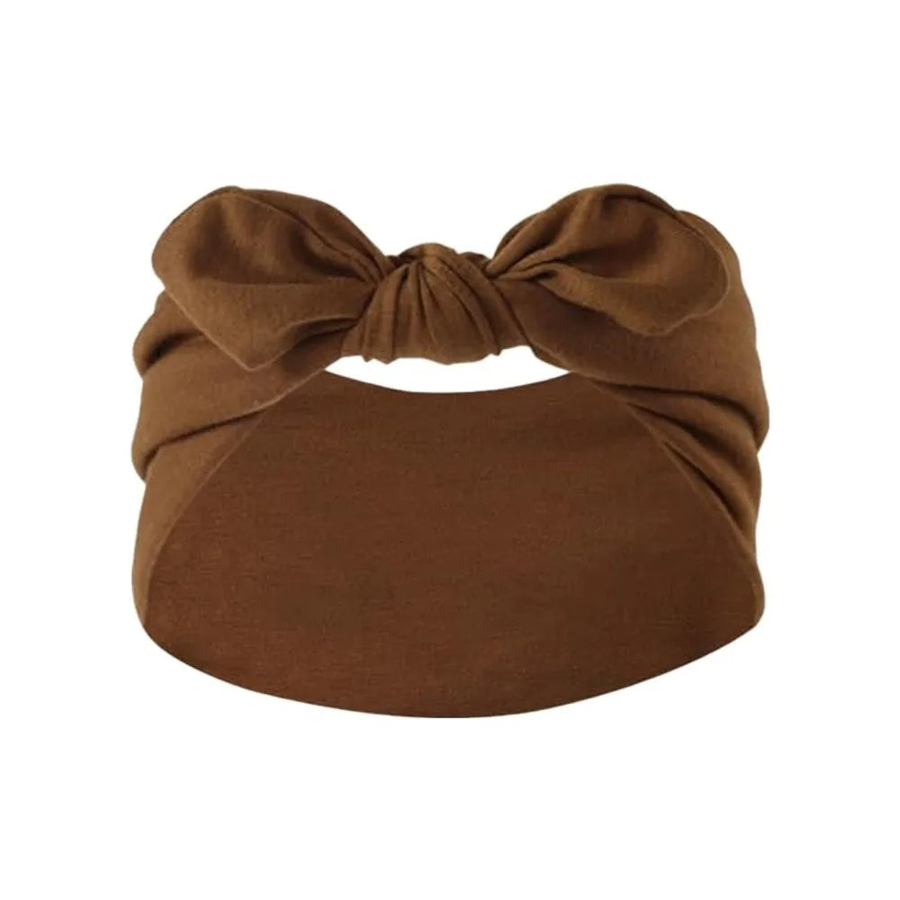 A brown velvet bohemian bunny ear headband tied in a bow.