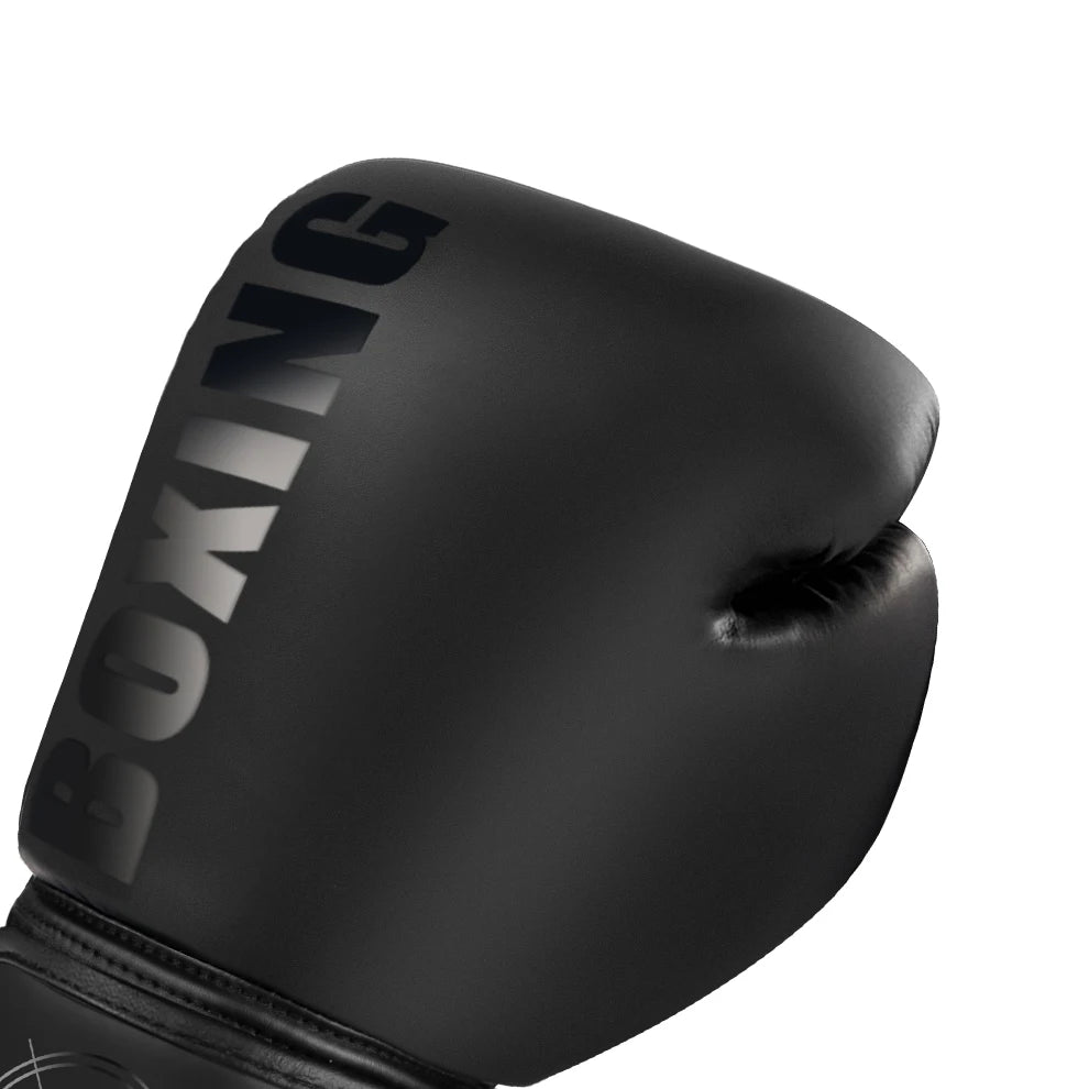 A close-up of a black boxing glove with the word BOXING printed on the knuckles.