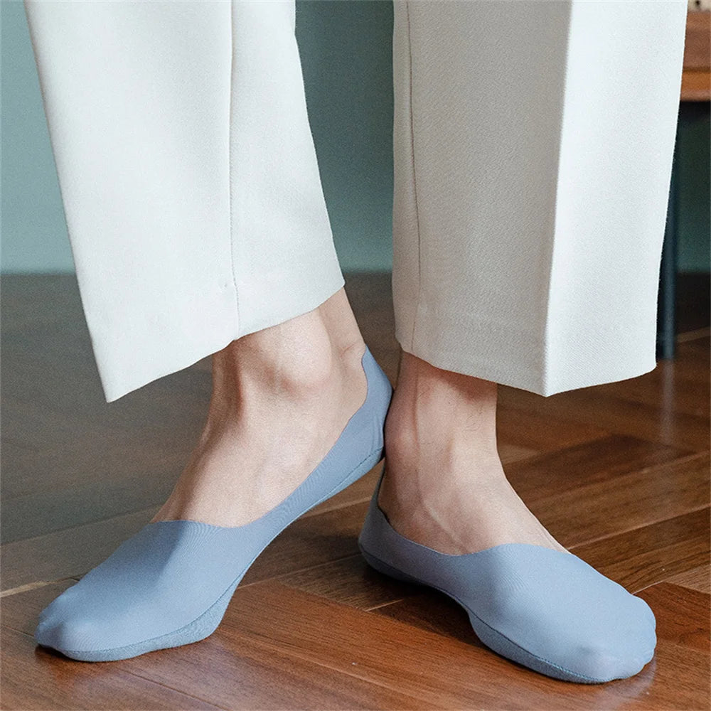 A pair of light blue men's invisible boat socks being worn on a person's foot.