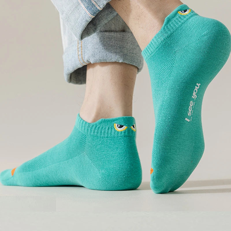 A pair of teal ankle boat socks worn on a person's foot and ankle.