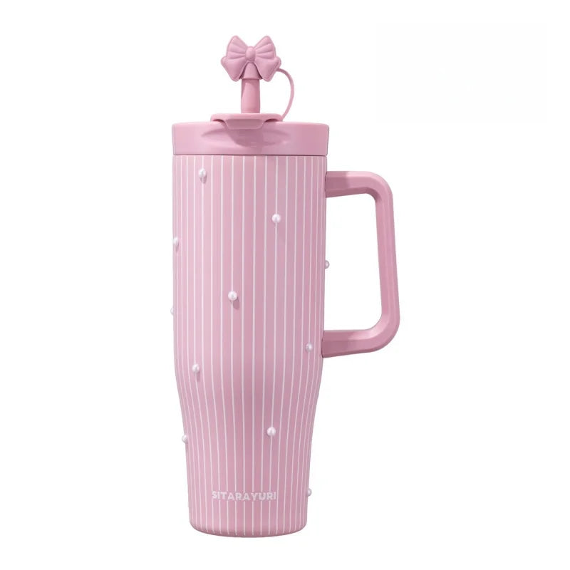 A pink insulated thermos mug with vertical stripes and pearl-like accents, topped with a bow.
