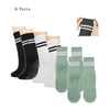 Six pairs of black and white grip socks for yoga and barre