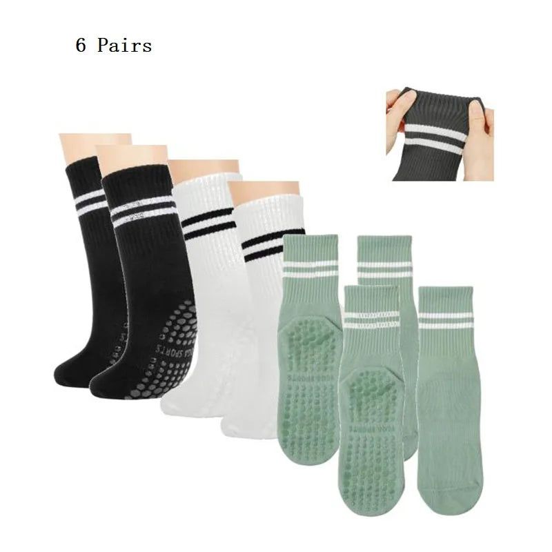 Six pairs of black and white grip socks for yoga and barre