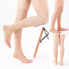 A pair of beige compression thigh high socks displayed on a mannequin leg.