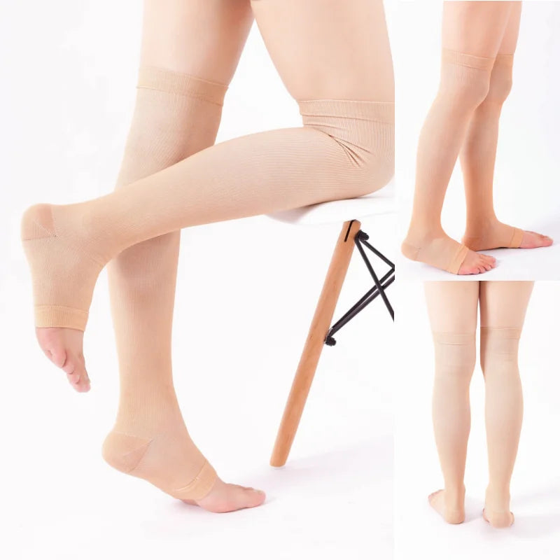 A pair of beige compression thigh high socks displayed on a mannequin leg.