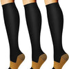 A set of three black women's compression socks with gold accents shown on legs.