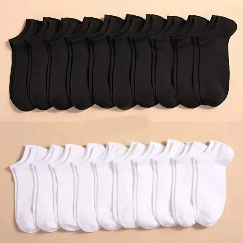 A set of black and white breathable unisex boat socks laid out in rows.
