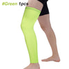A person wearing a bright lime green compression leg sleeve on their lower leg.