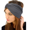 A woman wearing a gray boho wide turban headband on her hair.