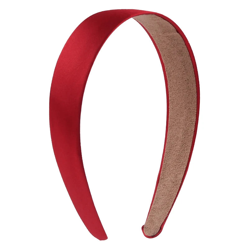 A pair of solid red satin hair bands for girls shown against a white background.